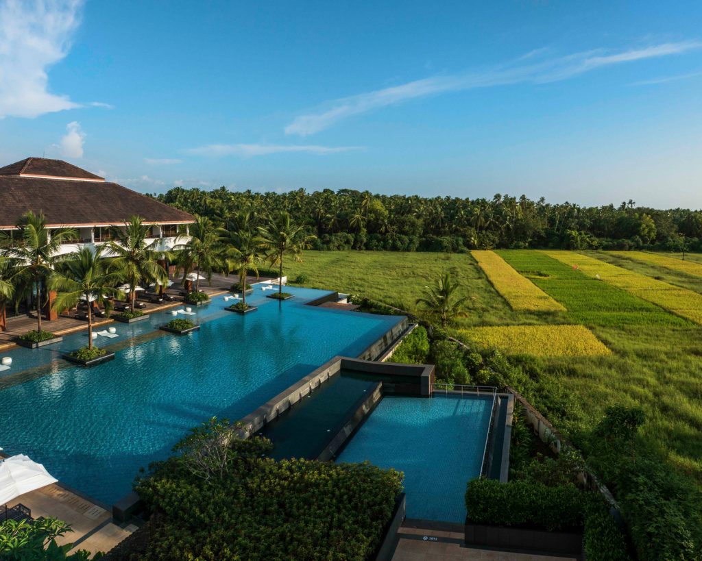 Alila Diwa Goa pool with green fields in the background