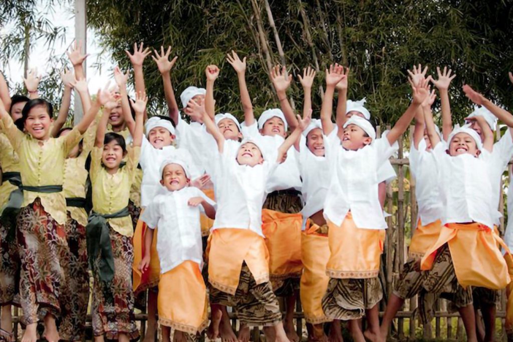 children lifting hands with joy