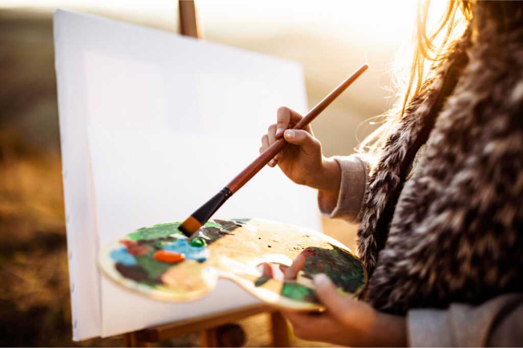 person painting on a blank canvas