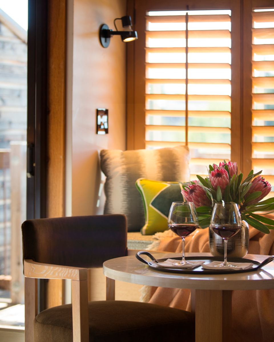 dining table with wine glasses and flower arrangement