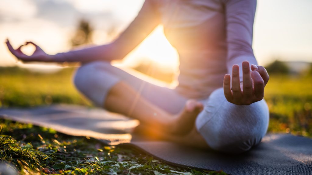 woman on a yoga mat meditating