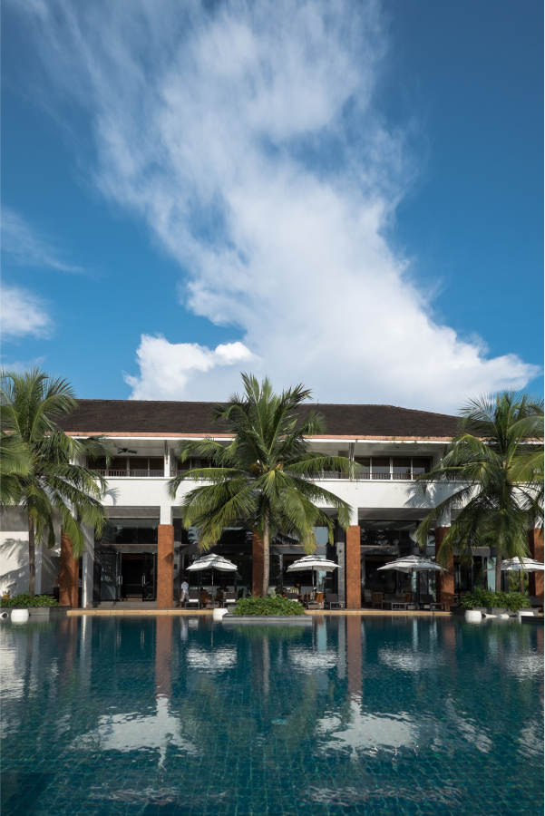 poolside with lawn chairs and palm trees