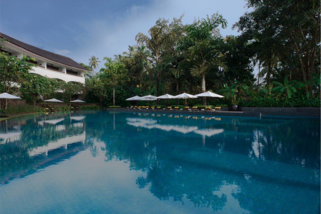 hotel pool with umbrellas and chairs