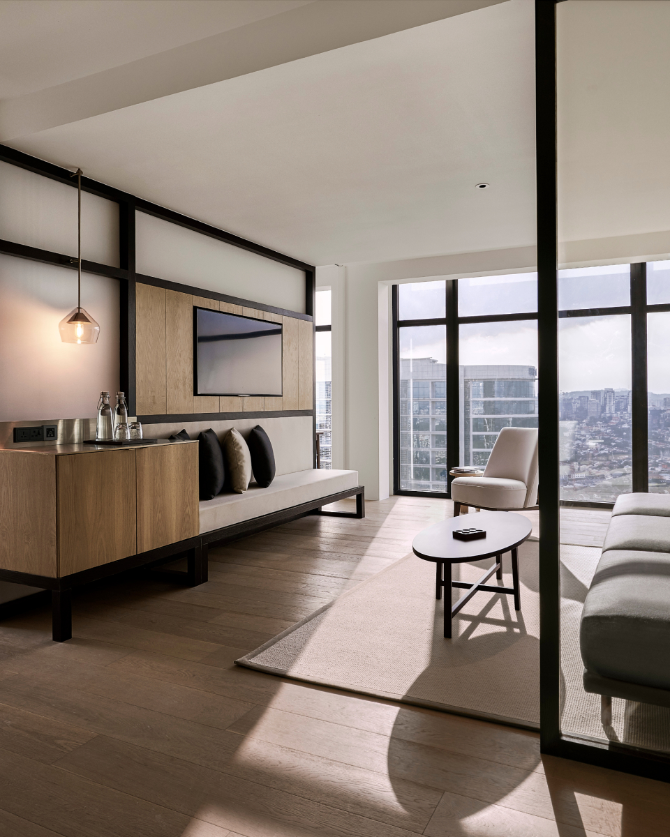 open space with floor to ceiling windows and a white couch and table