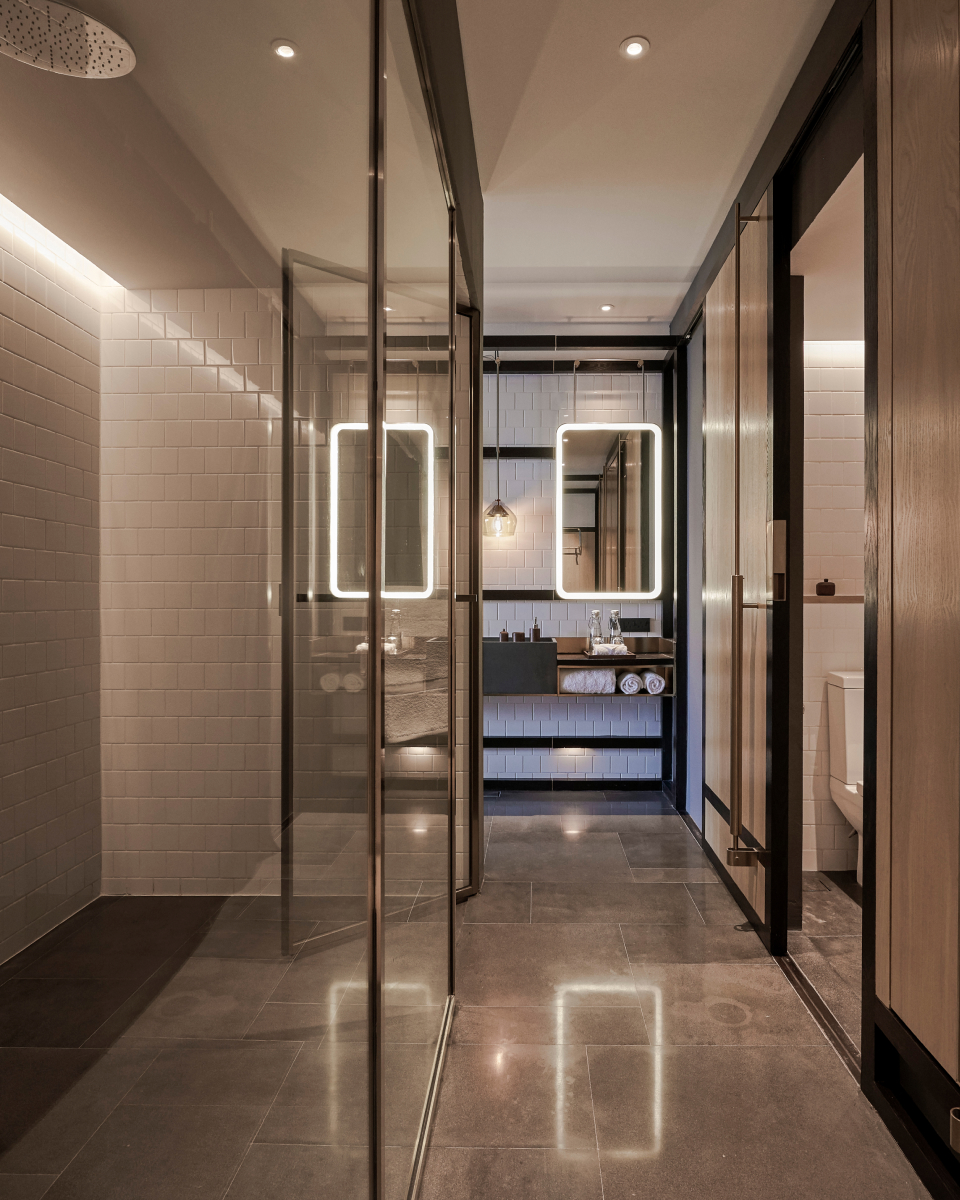 LED vanity and white tiled walls in bathroom