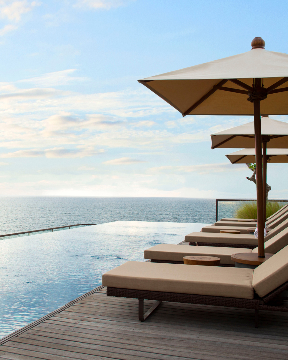 Lounge chairs and umbrellas next to pool