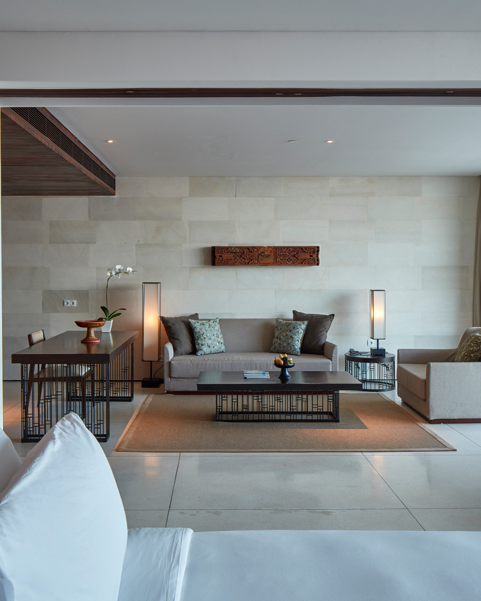 Cushioned couch and wooden tables in lounge area