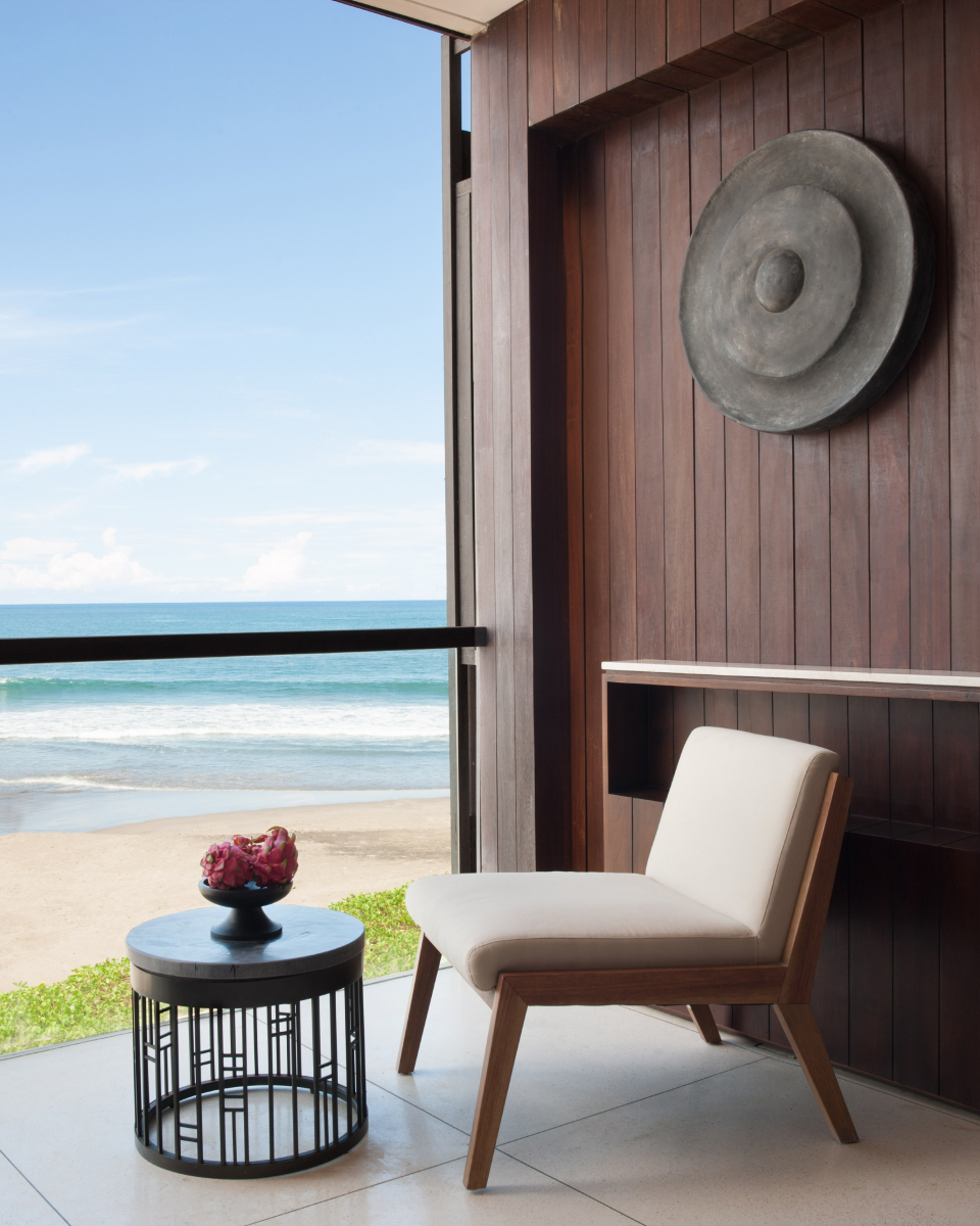 Cushioned chair with side table and an ocean view