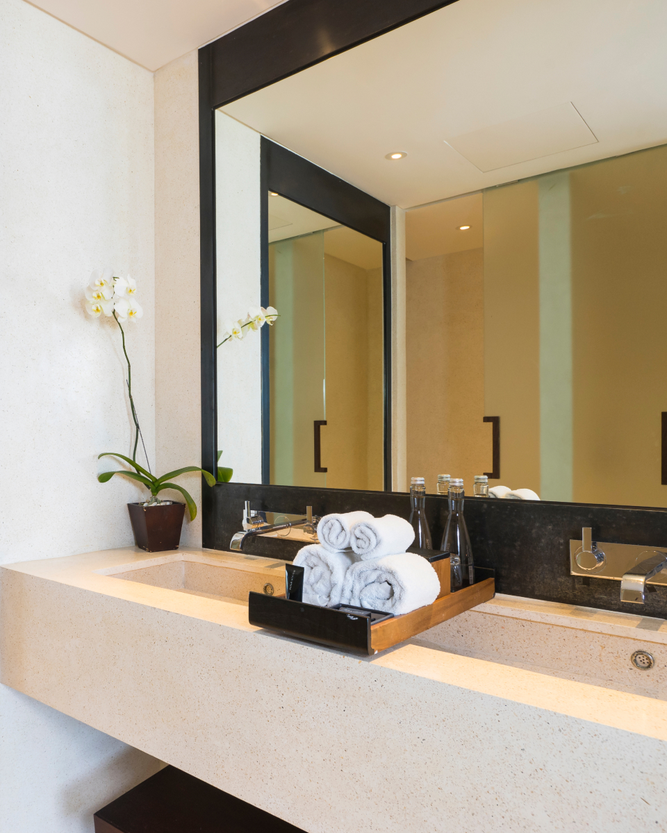 Bathroom mirror and neatly rolled hand towels