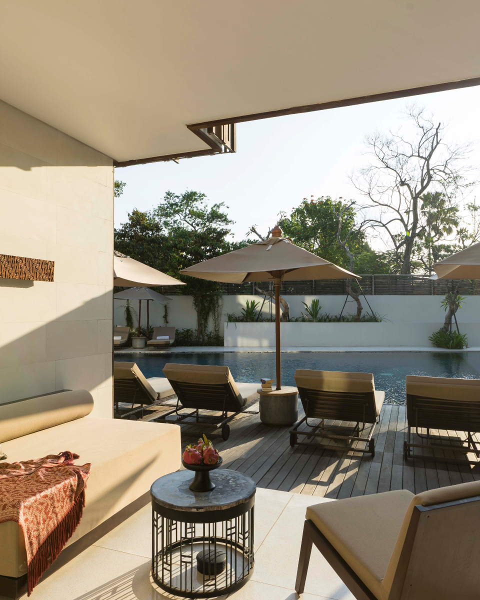 Lounge chairs with umbrellas by the pool side