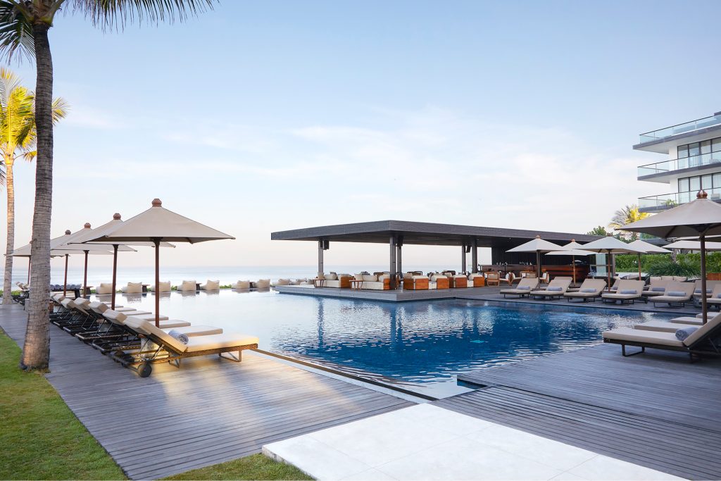 Pool view with lounge chairs and umbrella