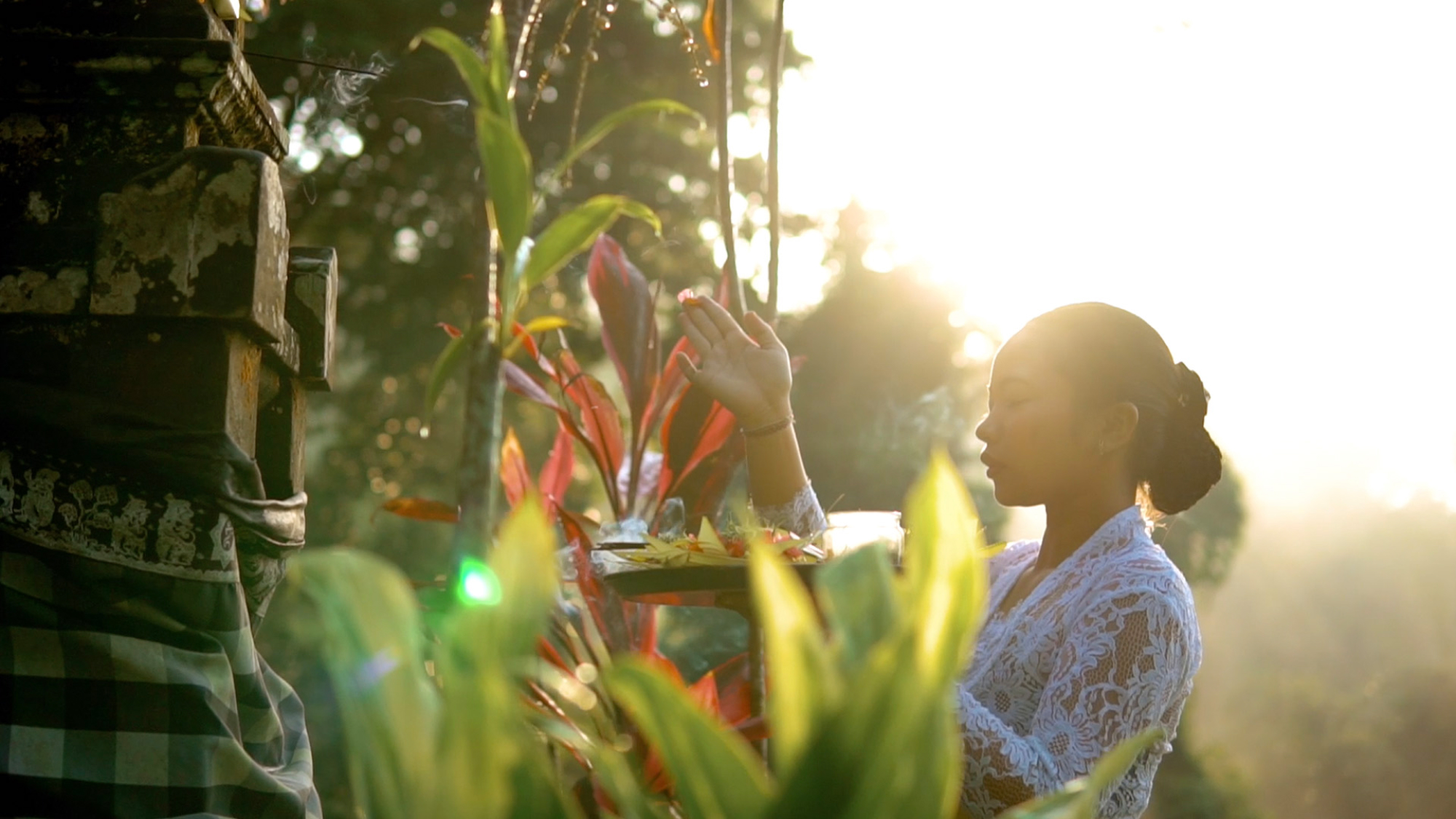 Woman standing by greenery