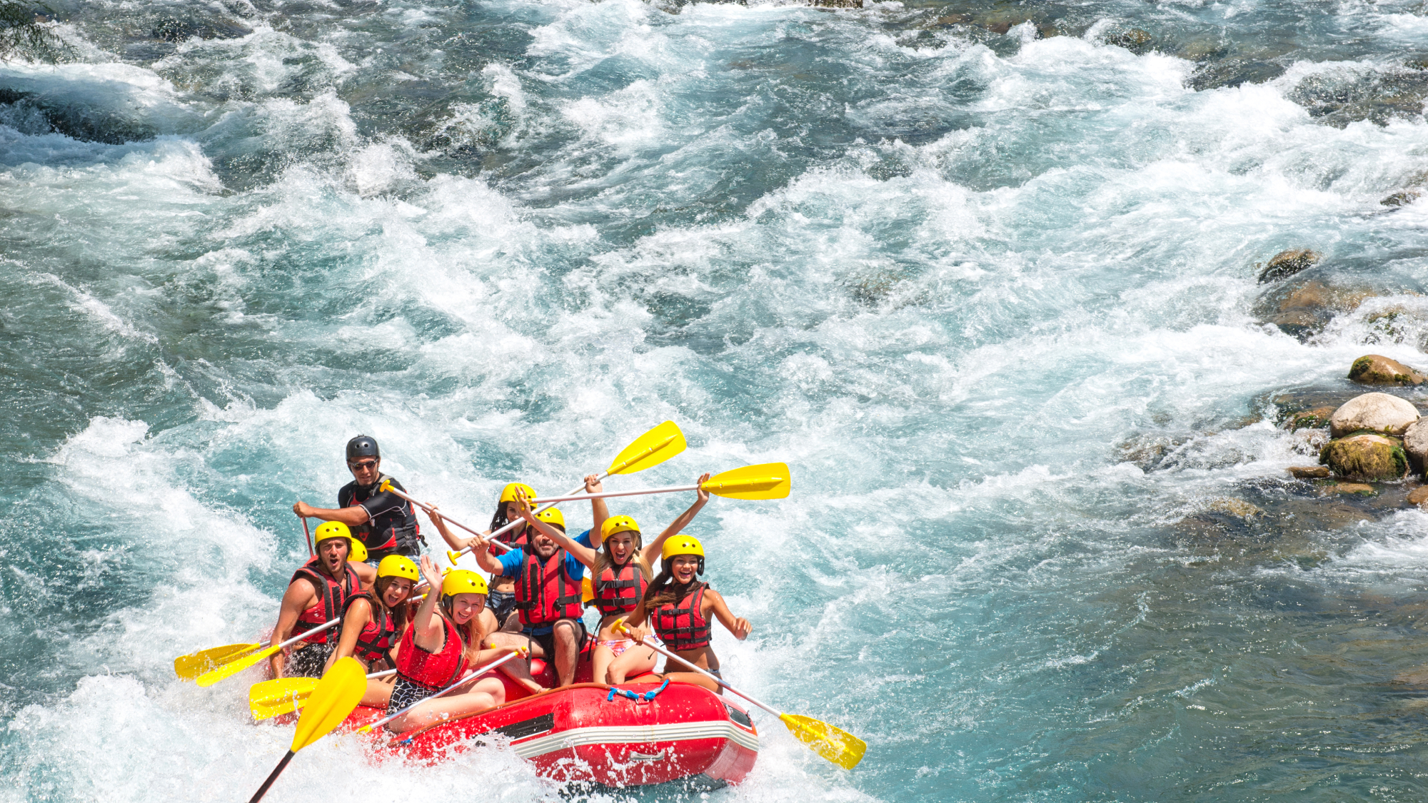 group of people white water rafting