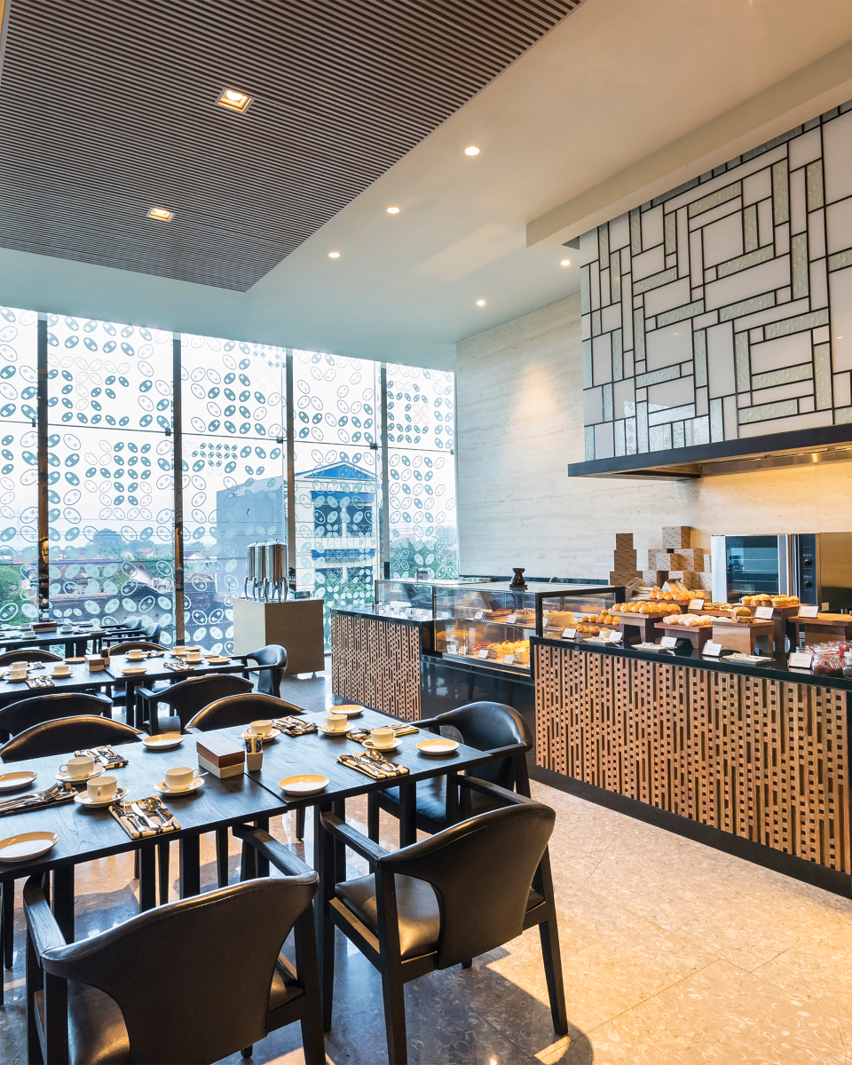 internal view of restaurant with chairs, tables and bakery selections