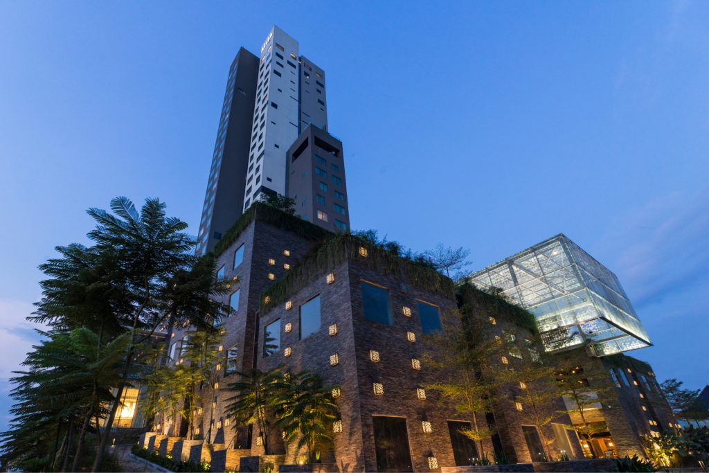 Nighttime shot of the hotel building looking up from the ground.