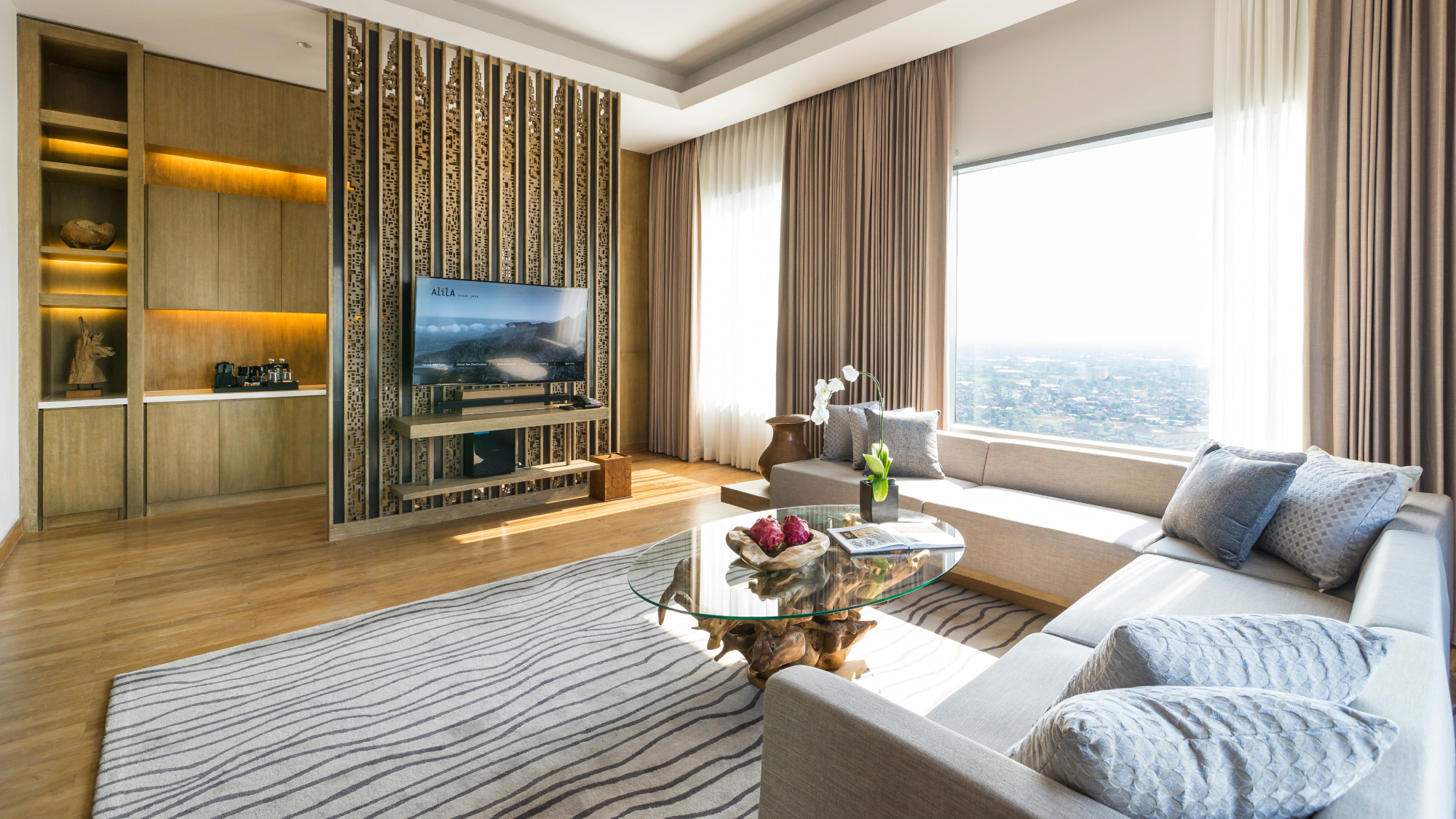 interior hotel room with TV, couch and coffee table